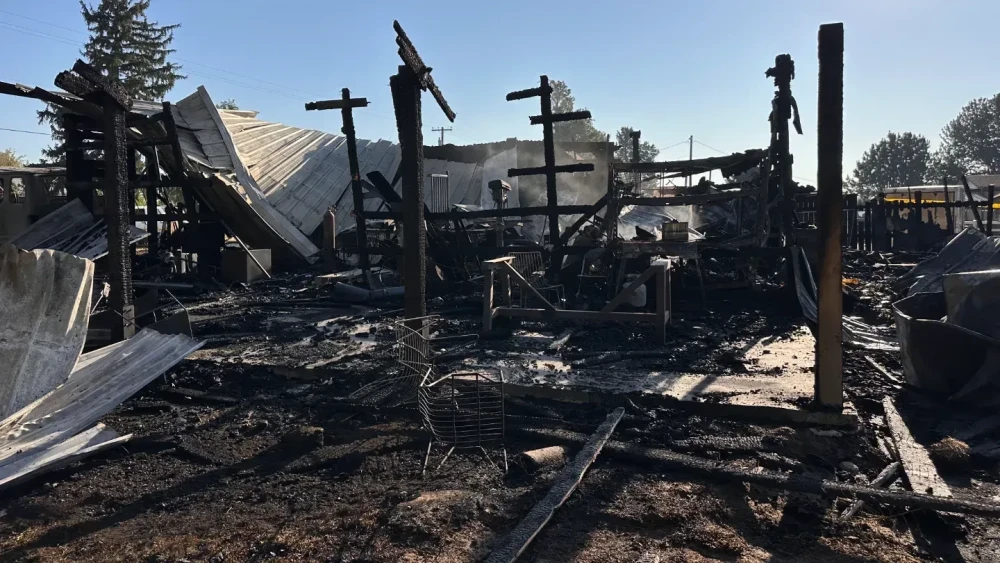 The family's home reduced to blackened beams, ash, and twisted metal after the fire