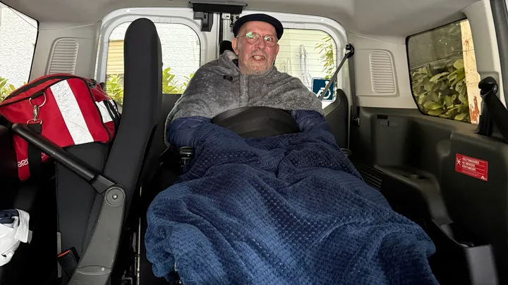 Terry Wayne Boggs seated in his wheelchair inside an accessible vehicle