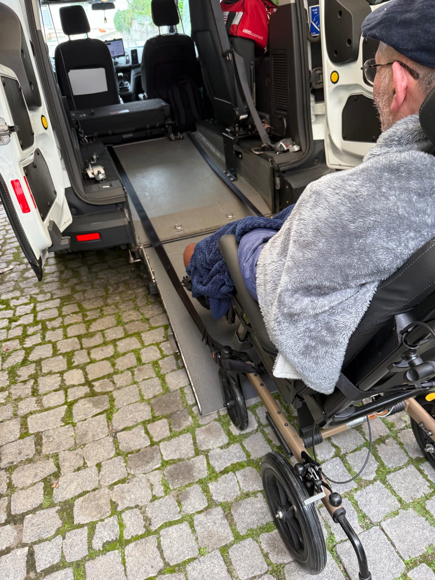 Terry approaching the ramp of an accessible vehicle in his wheelchair