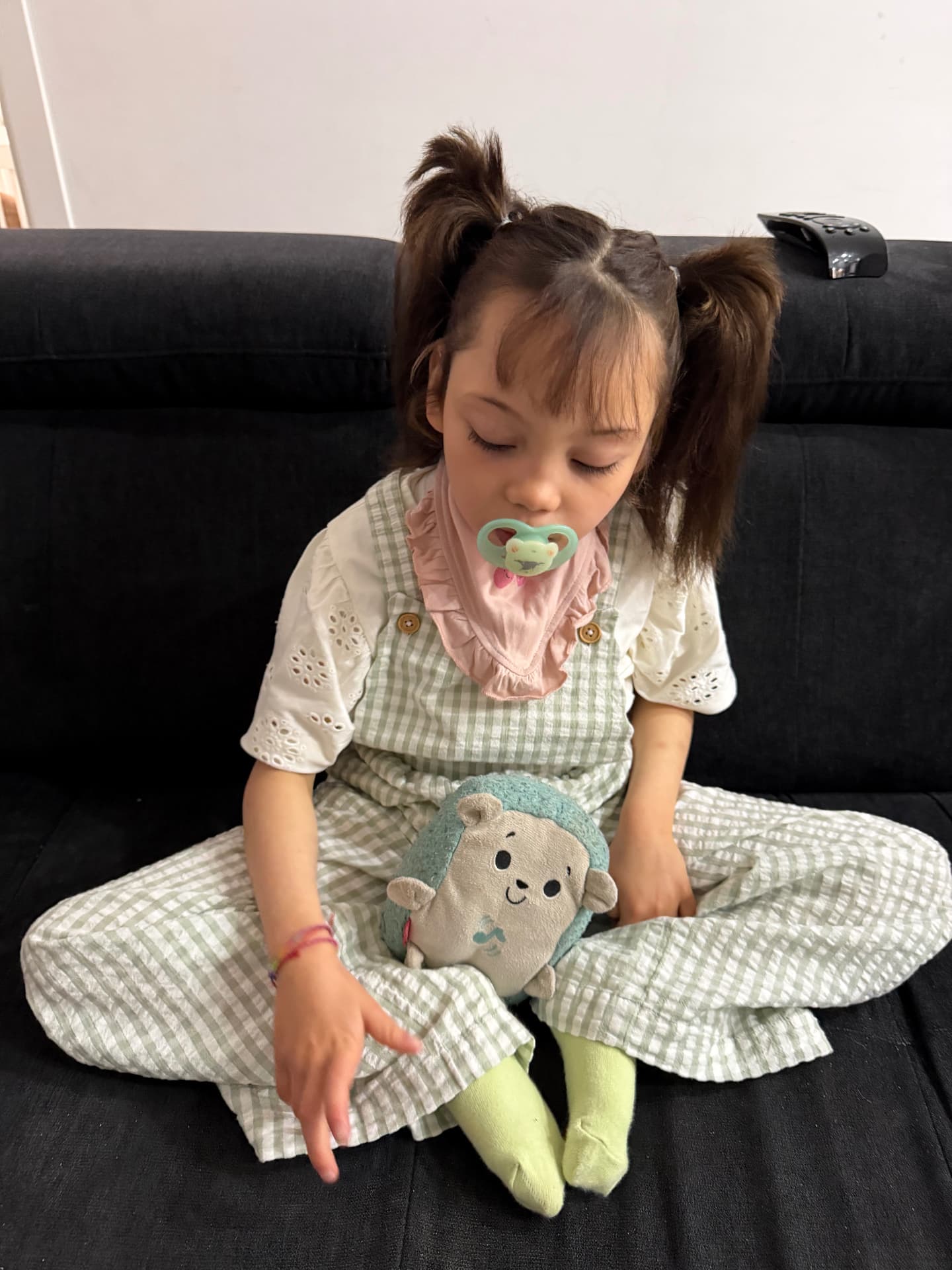 Sarah sitting at home with her favorite soft toy